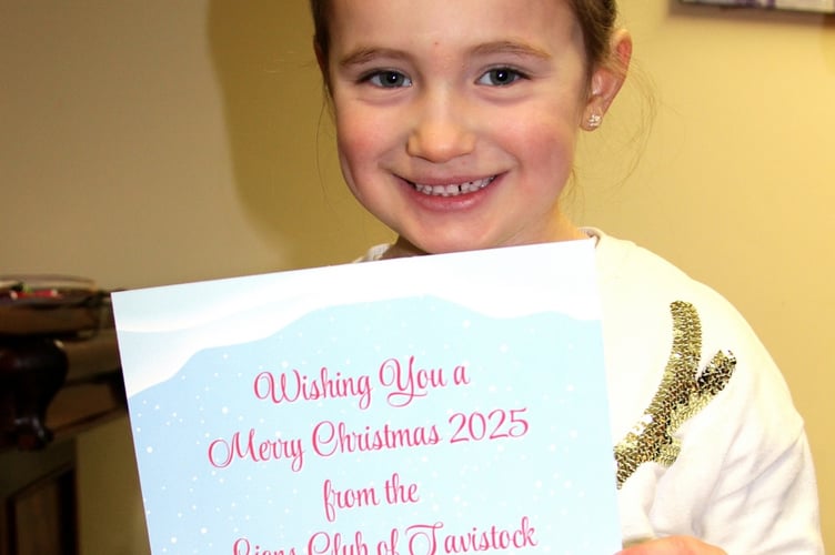 Rose with a souvenir as part of her Tavistock Lions charity Father Christmas Grotto experience.