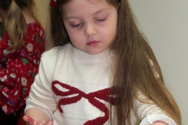Florence with her cookie as part of her Tavistock Lions charity Father Christmas Grotto experience.