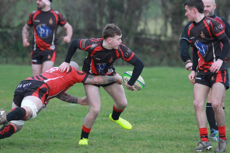 Off-loading under pressure from Tavistock Rugby Club's Boxing Day game Locals v Legends. Picture Chris Hair.