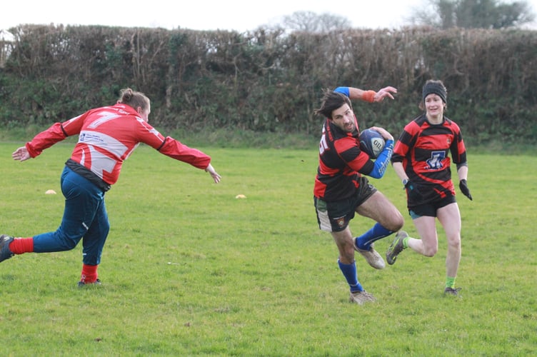 Evading a tackle T1 Tavistock Rugby Club mixed gender non-contact Boxing Day clash.  Picture by Chris Hair.