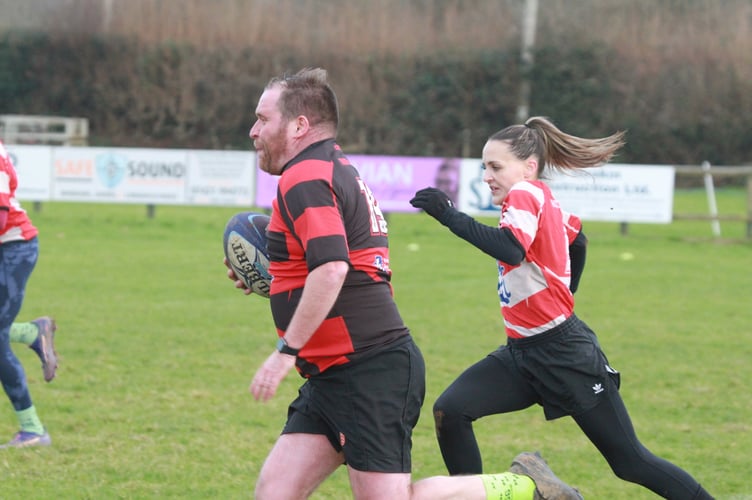 Closing for a tackle at the T1 Tavistock Rugby Club mixed gender non-contact Boxing Day clash. Picture by Chris Hair.