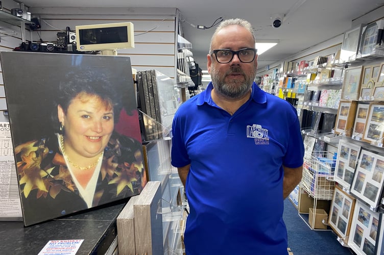 Keith Hall is selling his Dartmoor Photographic business which he inherited from his mum Kathie. He is standing next to a photographic portrait of her.