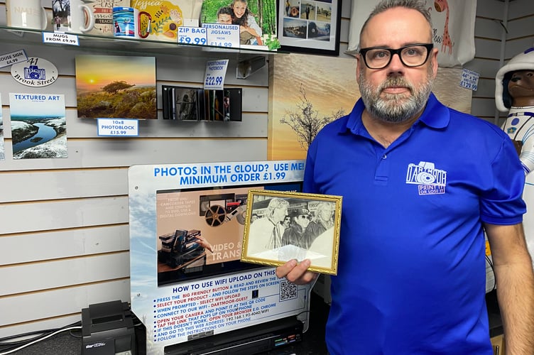 Keith Hall, former Dartmoor Photographic owner, with celebrity photo Elton John, Ian Botham and XX?