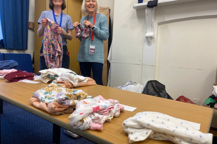 Tavistock Grow Baby group volunteers offer secondhand clothes at Tavistock Methodist Church.