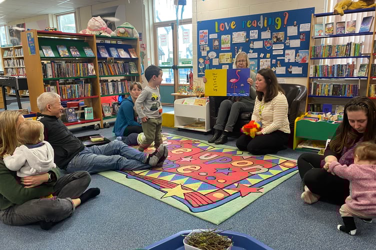 A sensory story telling session in Tavistock Library involves activity sessions to bring books alive.