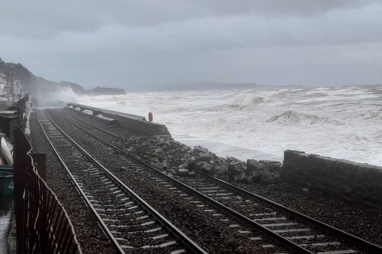 Renewed calls have been made for improvements to rail links to the SW after Storm Ingrid damage.  Photograph of the breached sea wall alongside the railway at Dawlish, by Tom Shiner-McGinley.
