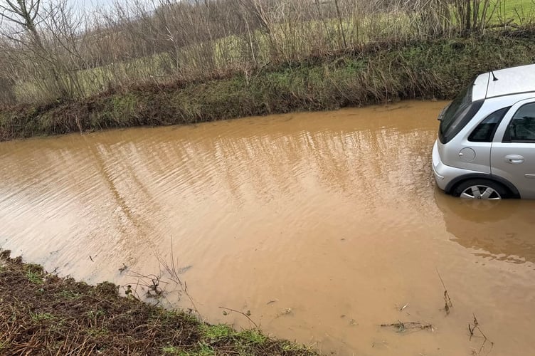 Tavistock firefighters rescued a couple from their car which was stranded on a flooded road after Storm Chandra.