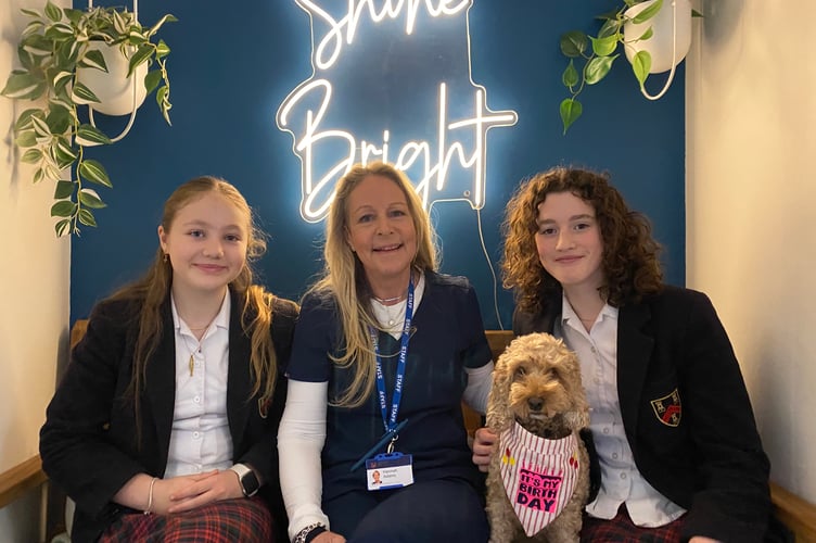 A school therapy dog, staff and pupils celebrate the launch of their new health and wellbeing centre at  Mount Kelly College in Tavistock.