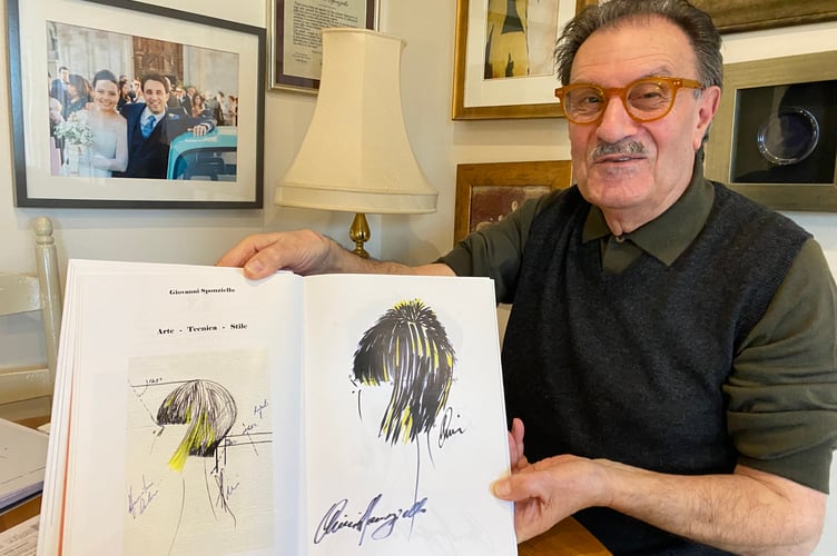 Giovanni Sponziello showing off his haridressing sketch designs for customers.