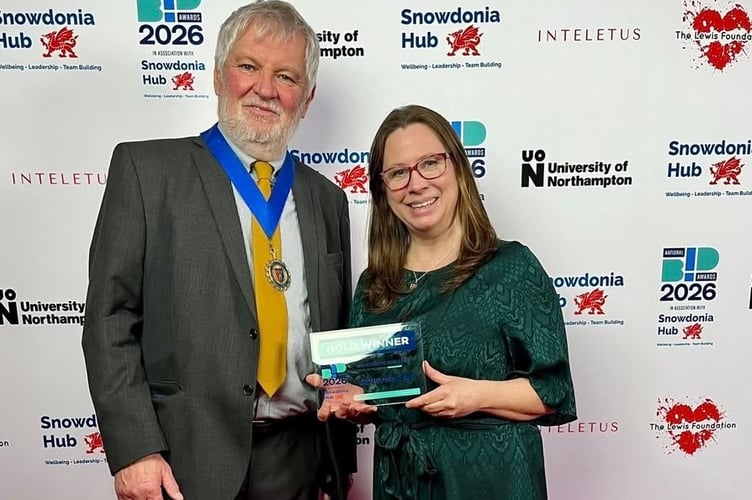 Tavistock mayor Cllr Steve Hipsey and Tavistock Bid manager Janna Sanders collecting the BID's gold award.