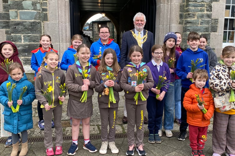 Bringing spring to the high street are schools and Brownie and Guide groups to mark Tavistock BID's Paint the Town project.