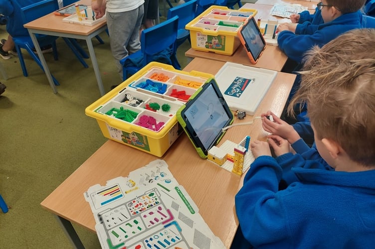 Teamwork at Lifton Community Academy during robot-building.