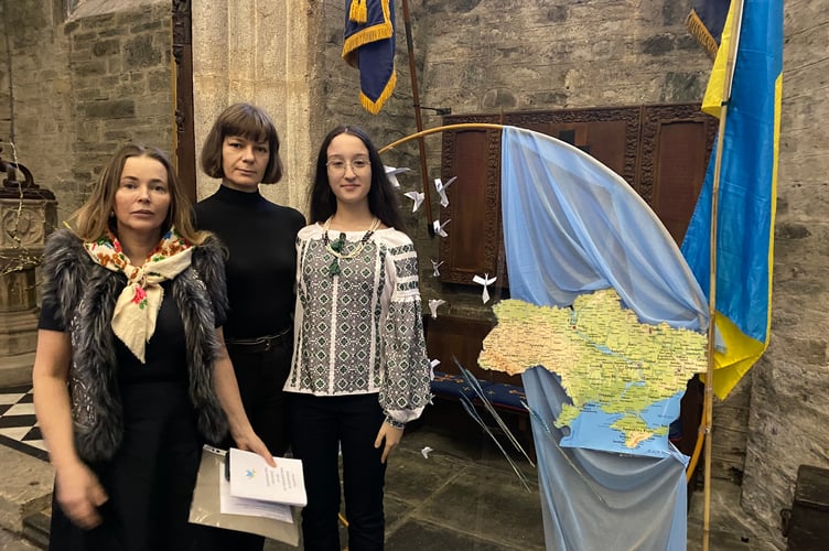Tatiana Kovalchuk, Halyna Filatova and Ailia Engin at St Eustachius' Church in Tavistock for a service marking the fourth anniversary of the Russian invasion of Ukraine. They are pictured with a map of Ukraine, the Ukrainian flag and paper peace doves.