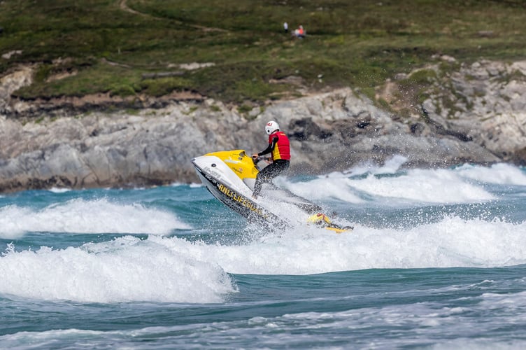 Lifeguard on a rescue watercraft in surf at Fistral beach