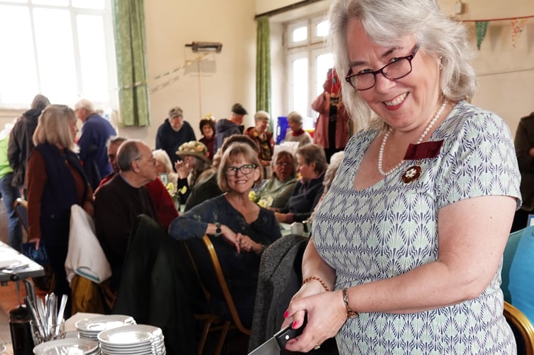 Nicola Gurr, Deputy Lieutenant of Devon, cutting the cakes made by Glenys Whelan, at the 20-year anniversary of the Bere Ferrers Community Shop. Picture by Ann Parsons.