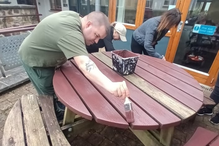 Residents and staff of Castleham Lodge extra care housing scheme, in Okehampton, improving the patio furniture.