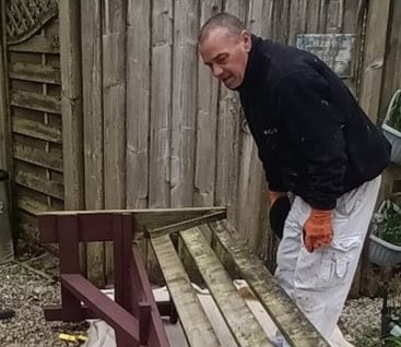 Renovating a patio bench by residents and staff of Castleham Lodge extra care housing scheme, in Okehampton.