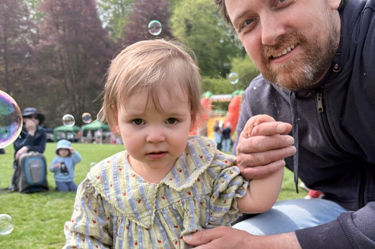 Eleanor Andrews (19 months) and her dad, Michael, enjoyed watching a bubble artist making giant bubbles.