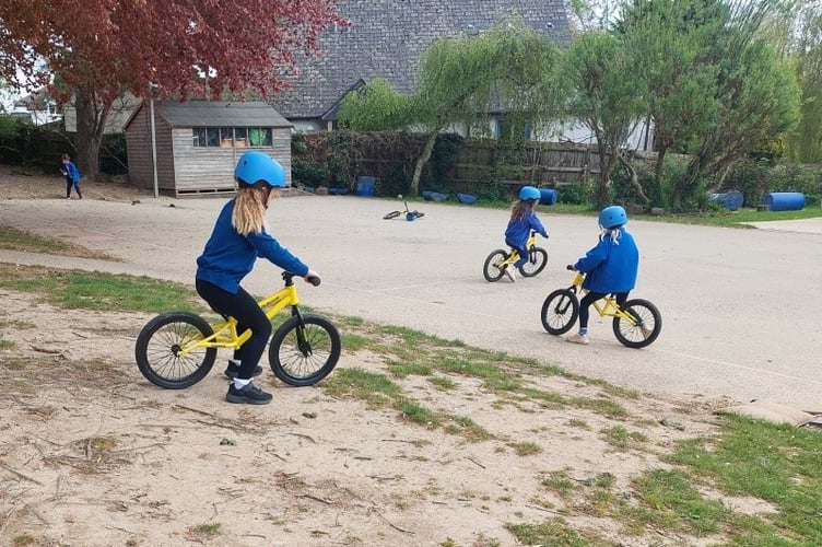Balance bikes are enjoyed by Lifton Community Academy pupils bought with funds donated by Tesco.