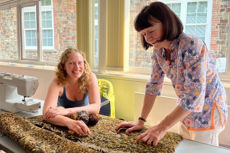 Naomi, left and Carole repairing a much loved rug at the Okehampton Repair Cafe.