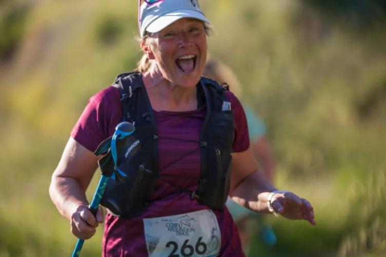 Janice Fuller smiling despite the heat and tough terrain of Corfu on a gruelling 15-mile night mountain running race.