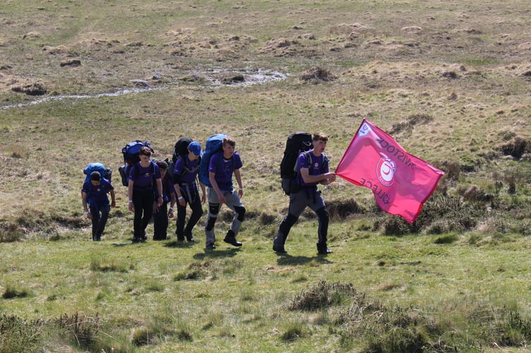 An adventurous Tavistock College 2026 Ten Tors team working as a team as they reel off the hills.