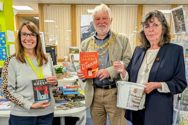Tavistock bookworms helped support the town mayor's charity in aid of the library by buying signed books. Pictured are Tavistock Mayor Cllr Steve Hipsey, mayor's consort Cathy Hipsey (right) and Tavistock librarian xxx