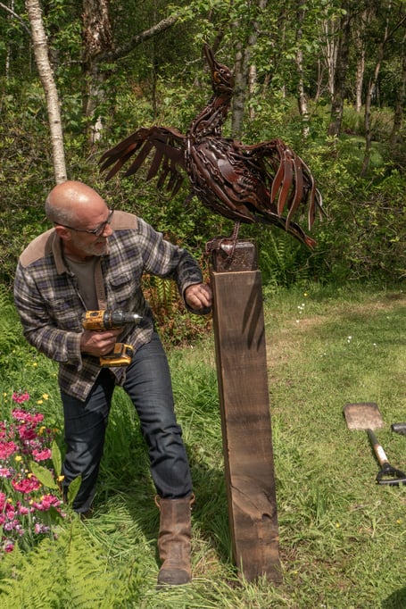 Mike Thompson installing one of the sculptures at Stone Lane Gardens near Chagford, which begins on May 30.