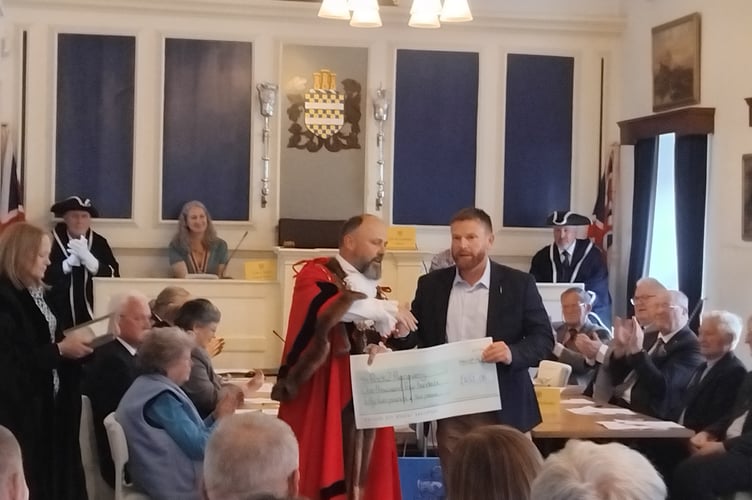 Mayor of Okehampton Cllr Richard Colman presents the cheque to Brian from Rock2Recovery at the ceremony.