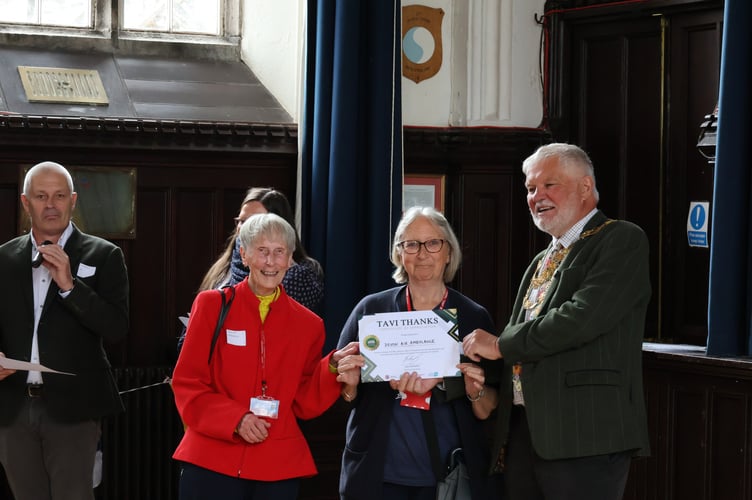 Tavistock Mayor Cllr Steve Hipsey presents a Tavi Thanks award to Devon Air Ambulance volunteers.