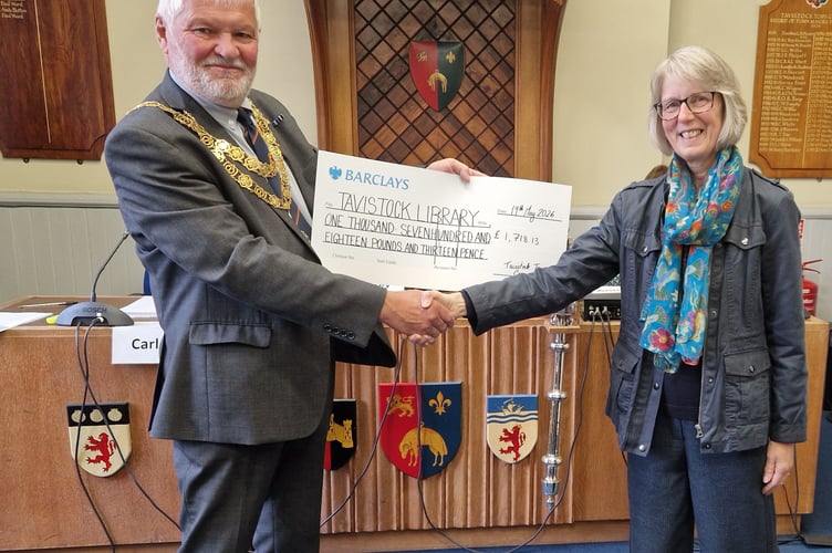 Tavistock's retiring mayor Cllr Steve Hipsey is pictured presenting a cheque with the proceeds of his mayoral charity to Tavistock Library manager Jan Horrell.