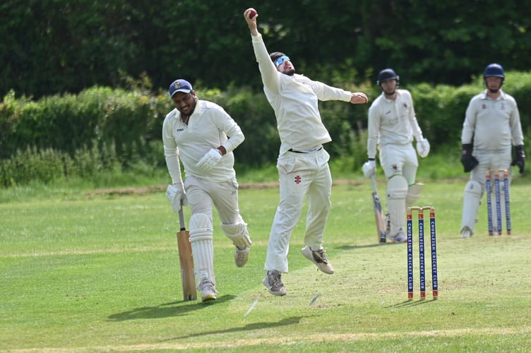 Devon Cricket League C Division West. Chudleigh versus Hatherleigh 2nd XI. Hatherleigh's bowler Greg Solkin reaches high but Chudleigh batsman Yogi Yogesh is across the crease
