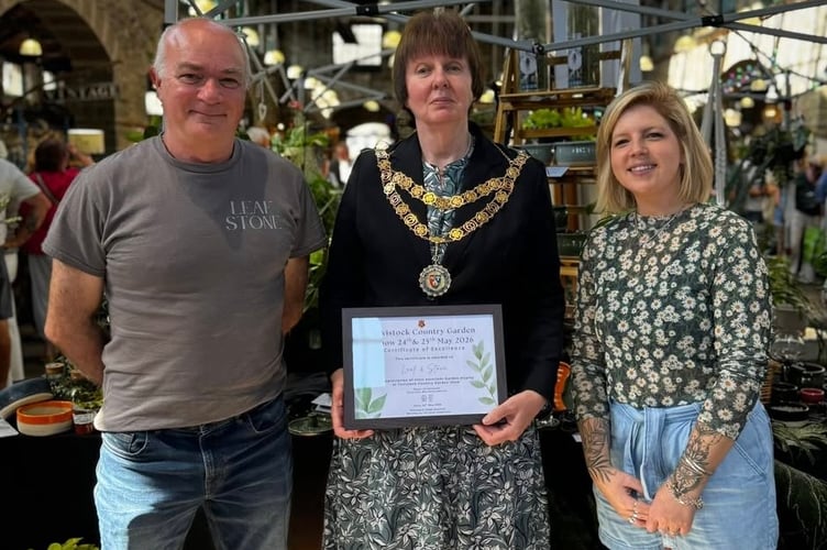 Leaf and Stone is presented with a Tavistock Country Garden Show certificate by newly-elected town Mayor Cllr Anne Johnson in the Pannier Market. Picture by Tavistock Town Council.
