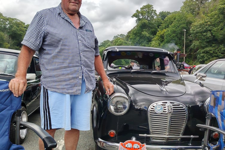 A proud driver with his classic car at the Robey Trust Tavistock Steam Fair.