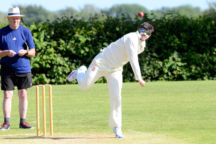 56_Greg_Solkin_Hatherleigh spin bowler Greg Solkin runs past umpire Bob Heaman on the way in to bowl against Abbotskerswell. His side lost by seven wickets_1684 copy