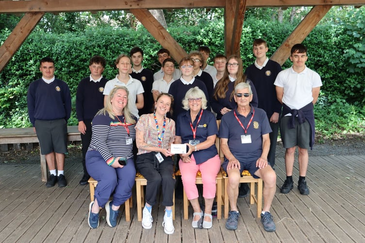 Members of Okehampton Rotary Club visiting Okehampton College to present a donation to the neurodiverse group at the college. It will be used to fund extracurricula activities.