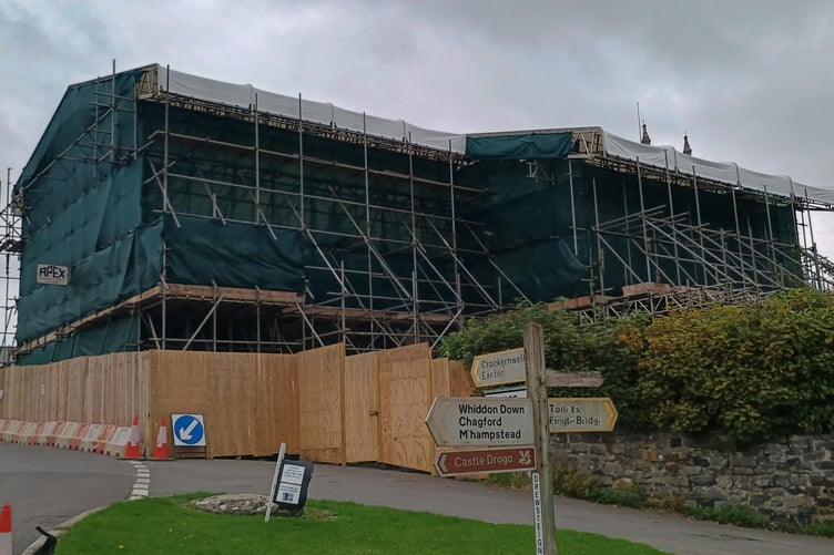 A tarpaulin covers the fire damaged cottages in Drewsteignton where restoration work will soon begin.