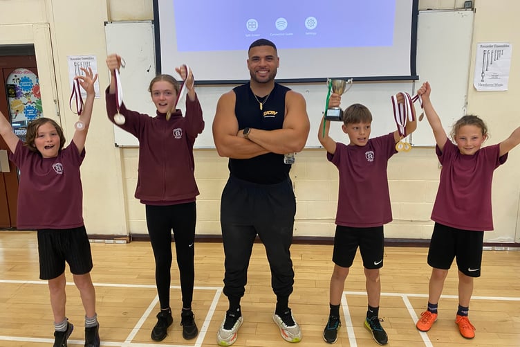 Sporting youngsters met their TV hero Gladiator who presented them with sport day medals.