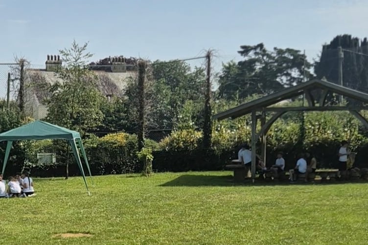 Bere Alston Primary School children enjoy adapted maths lessons in the outdoor shade during the heatwave.