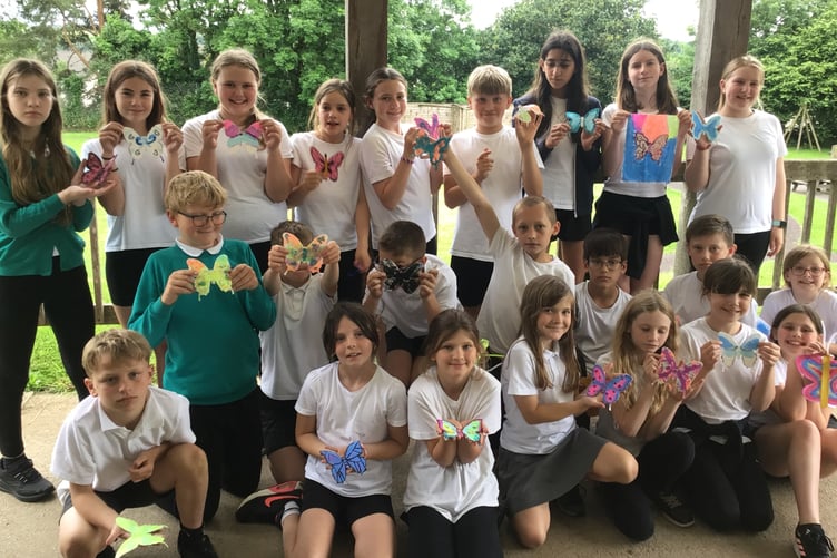Students from Winkleigh Primary School showcase their butterfly creations.