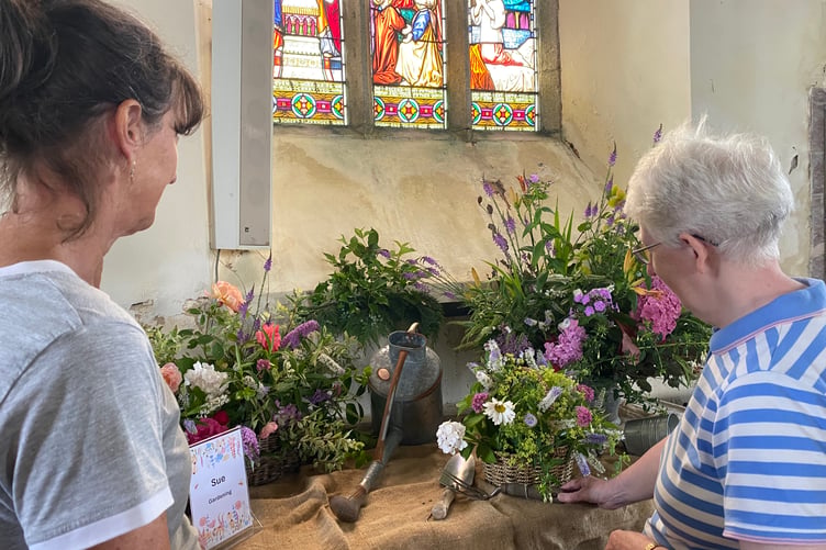 Admiring Sue Champion's Garden-themed display at Milton Abbot Church Flower Show.