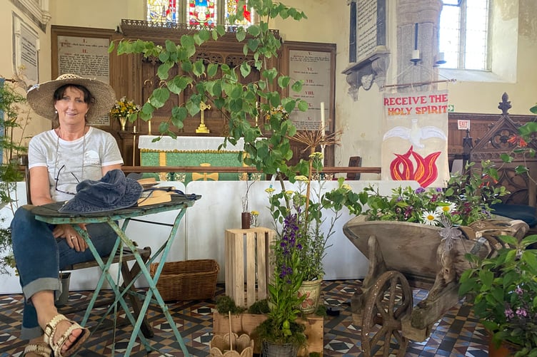 Sitting pretty at Milton Abbot Church Flower Show: Show organiser Angie Williamson at Endsleigh Walled Gardens display by Kayleigh and Ben Scott.