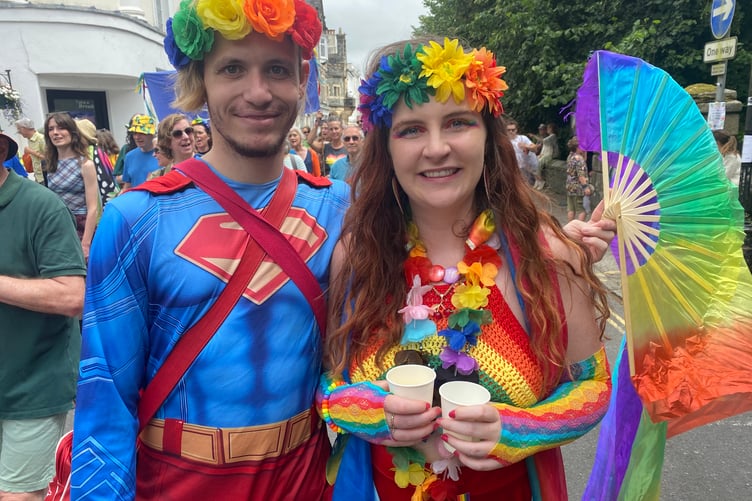Two colourful friends join in TaviPride's street parade celebrating community, diversity and friendship.