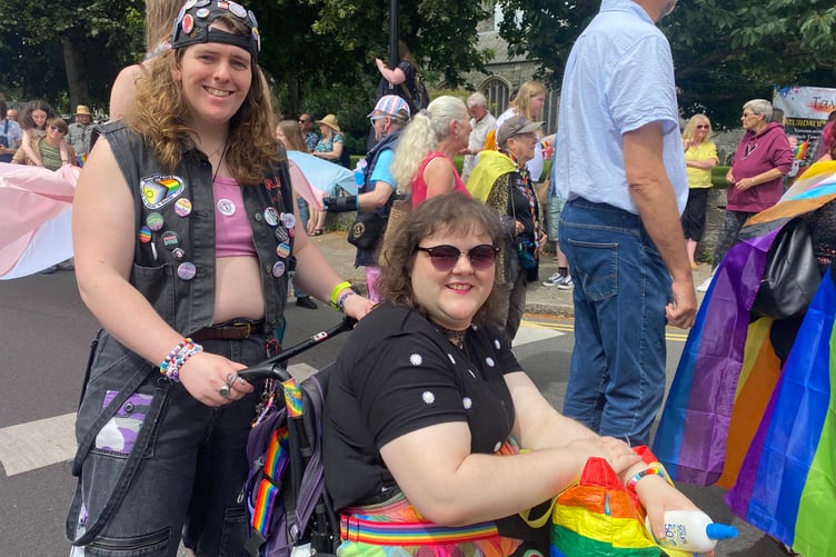 Two friends join in the fun at TaviPride's street parade.