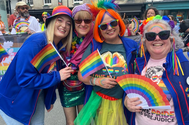 Friends fly the colours at the TaviPride parade.
