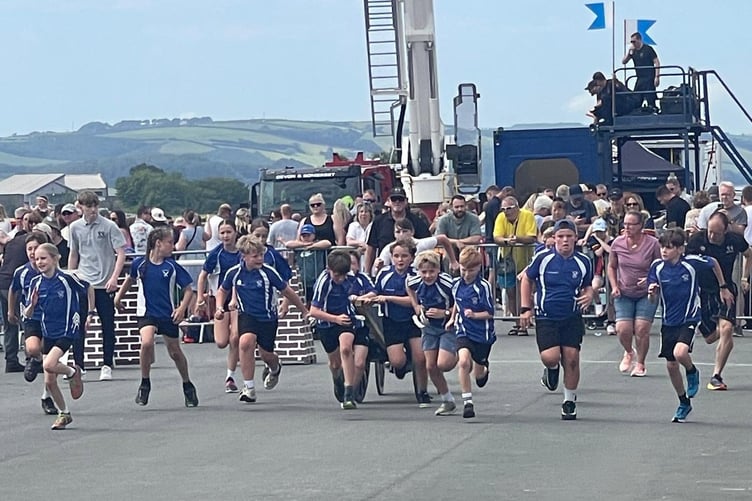 Straining every sinew: Pupils of St Andrews Community Academy in Buckland Monachorum racing in the junior field gun competition at Armed Forces Day.