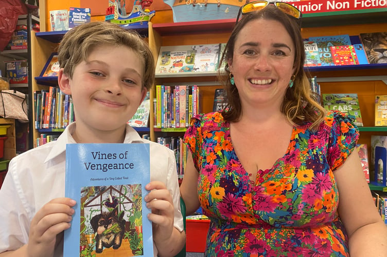 Jack and mum Laura Sweet, of Gunnislake, with their jointly written children's story book 'Vines of Vengeance' in Tavistock Library.