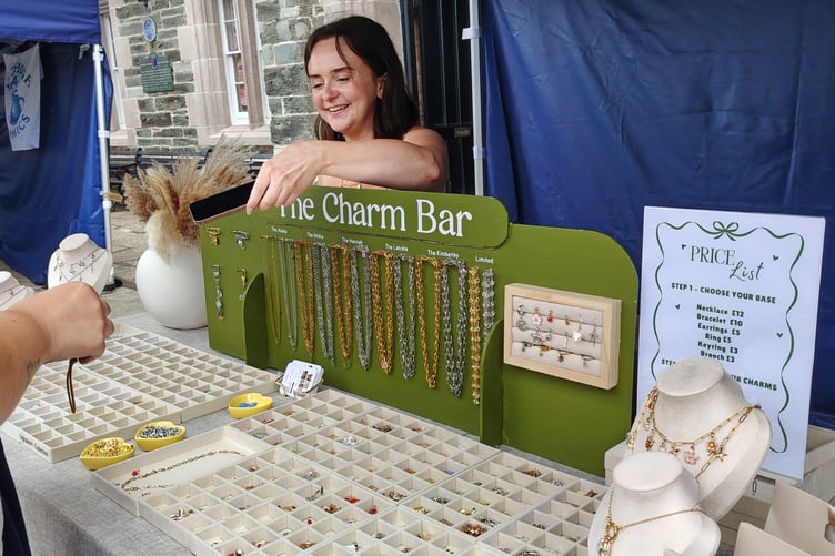 A young trader selling her charms and learning the ropes while being judged at the young market traders SW competition in Tavistock.
