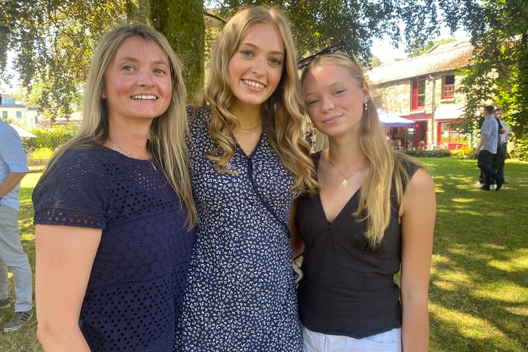 Two student friends at Tavistock College GCSE year 11 graduation ceremony at Tavistock's St Eustachius' Church. Centre May (year 11 leaver) and friend Megan (Tavistock College A-level graduate.