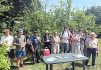 Okehampton College students present handmade tree tags for allotment orchard